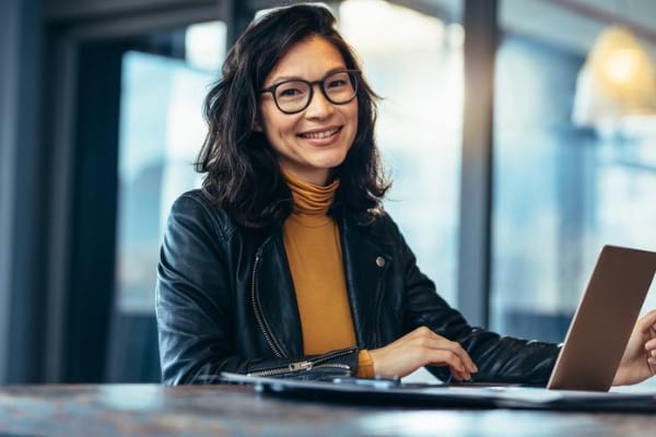 Woman smiling at computer